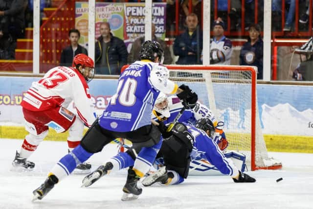Scott Robson and Petr Stapanek help Janis Auzins keep out Swindon Wildcats. Picture: Tom Scott