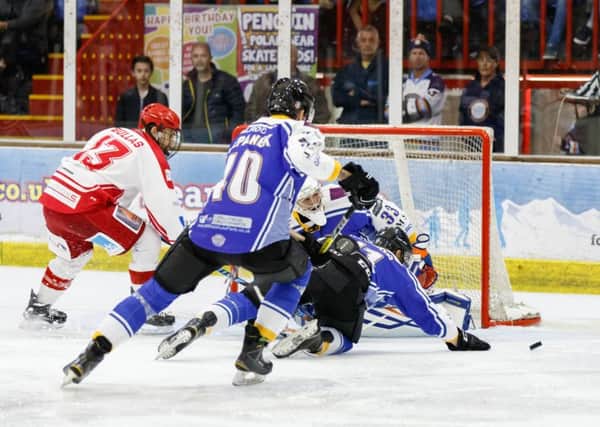 Scott Robson and Petr Stapanek help Janis Auzins keep out Swindon Wildcats. Picture: Tom Scott