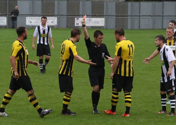 Holbeach striker Jake Clitheroe (10) is sent off by referee Michael Dunkley during the win over Peterborough Northern Star. Photo: Tim Gates.
