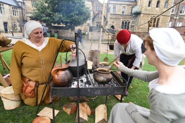 Heritage open days in Peterborough.  Re-enactors from the Deads of Arms cooking in encampment at Cathedral EMN-161109-100221009