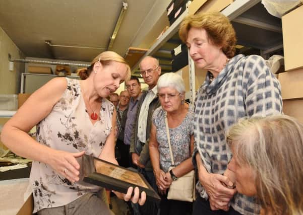 Heritage open days in Peterborough.  Glenys Wass, the collections manager at Peterborough Museum showing visitors artifacts in the vaults. EMN-161109-100043009