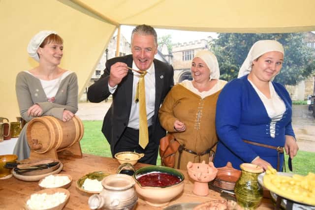 Heritage open days in Peterborough. Re-enactors from the Deads of Arms cooking in encampment at Cathedral -  Nicola Hibbard, Susie Baker and Chloe Baker with mayor David Sanders tasting foods. EMN-161109-100209009