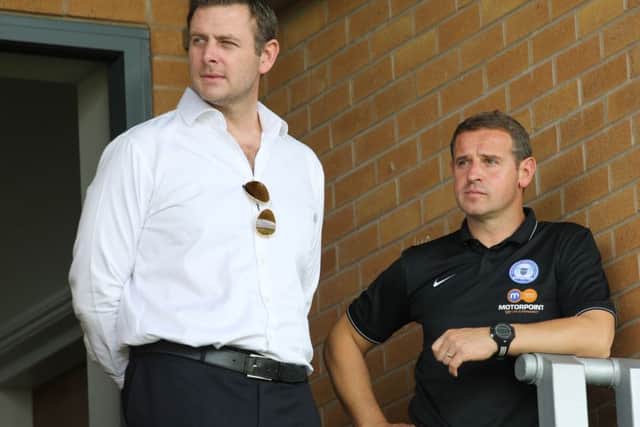 Darragh MacAnthony with former Posh manager Dave Robertson.