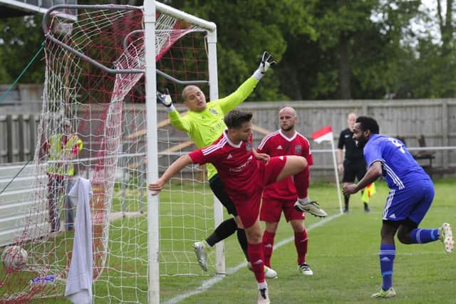 Peterborough Sports striker Avelino Vieira (blue) is a transfer target of higher-level St Neots.
