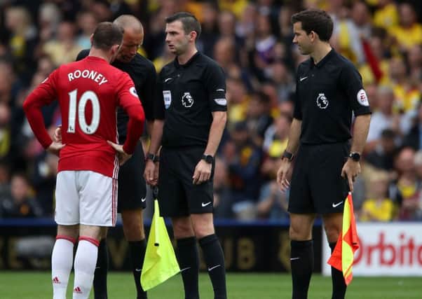 Wayne Rooney arguing with officials for a change.