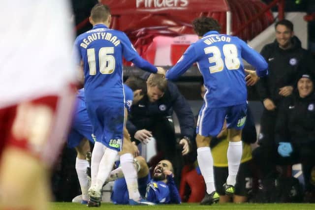 Erhum Oztumer (on floor) celebrates a goal at Sheffield United with Grant McCann and team-mates. Photo: Joe Dent/theposh.com.