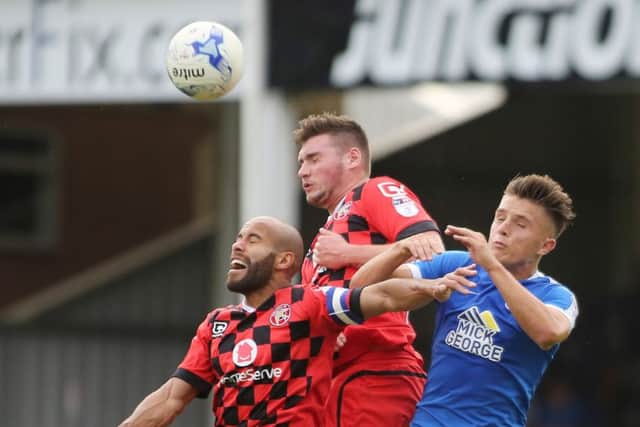 Posh striker Tom Nichols in an ariel duel with two Walsall defenders. Photo: Joe Dent/theposh.com.