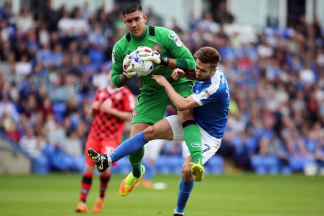 Outstanding Walsall goalkeeper Neil Etheridge beats Posh midfielder Gwion Edwards to the ball. Photo: Joe Dent/theposh.com.
