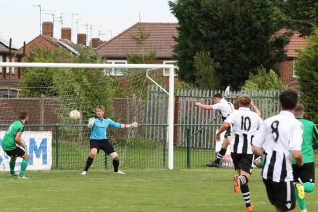 Harley Williams heads home the third goal for Peterborough Northern Star against Blackstones. Photo: Tim Gates.
