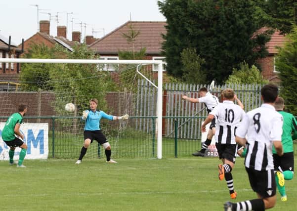 Harley Williams heads home the third goal for Peterborough Northern Star against Blackstones. Photo: Tim Gates.
