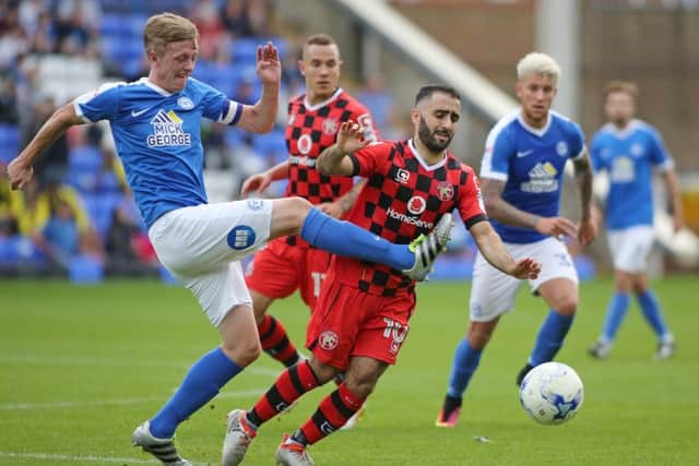 Posh skipper Chris Forrester battles with his former team-mate Erhun Oztumer during the 1-1 draw with Walsall. Photo: Joe Dent/theposh.com.