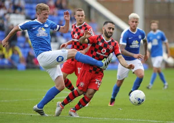 Posh skipper Chris Forrester battles with his former team-mate Erhun Oztumer during the 1-1 draw with Walsall. Photo: Joe Dent/theposh.com.