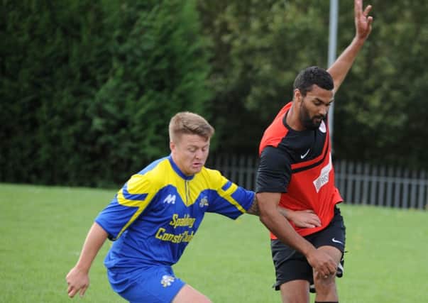 Action from the Peterborough League Division Two draw between Parkway Eagles (red) and Spalding Town. Photo: Chris Lowndes.