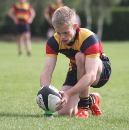 Ollie Mann kicks for goal.