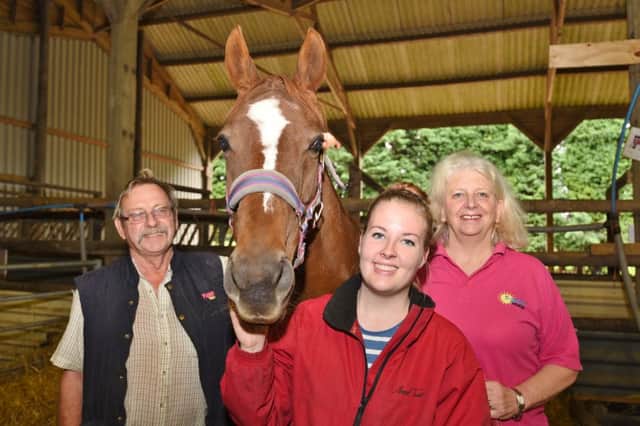 Bob and Linda Moore, owners of  Pigeons Farm, Thorney  with their animal carer Phoebe Clark. The farm is due to close shortly EMN-160927-165708009