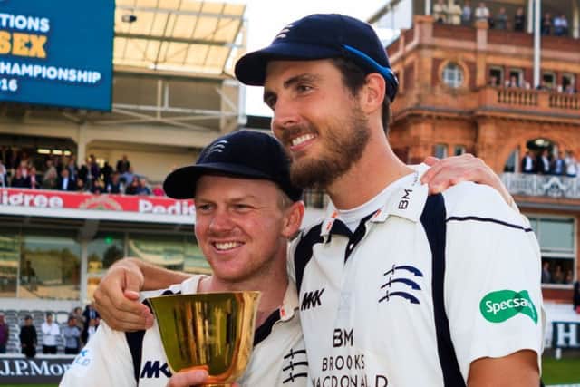 Middlesex players Sam Robson and Steven Finn (right) with the County Championship trophy.