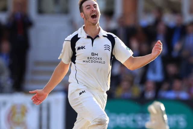 Toby Roland-Jones celebrates the wicket that clinched the County Championship title for Middlesex.