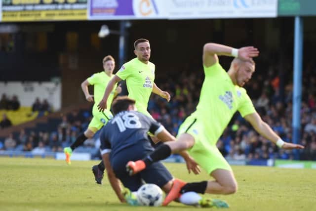 Posh star Marcus Maddison is tackled on the edge of the Southend penalty area. Photo: David Lowndes.
