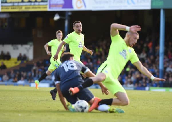 Posh star Marcus Maddison is tackled on the edge of the Southend penalty area. Photo: David Lowndes.