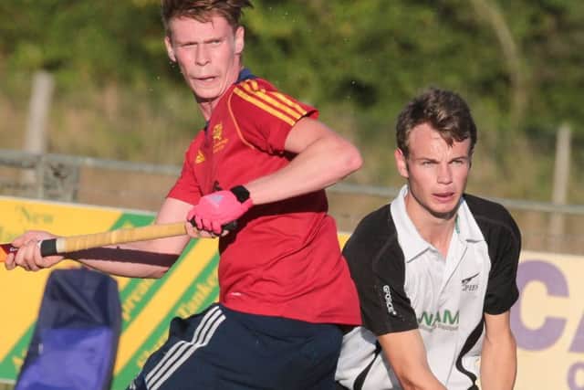 Ross Ambler of City of Peterborough takes evasive action during the win at Harleston.