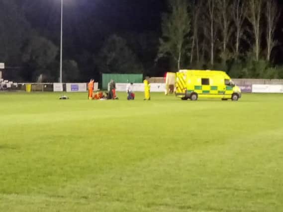 King's Lynn Town player Matty Castellan being treated on the pitch at St Ives for a head injury. Photo: LUKE HAMPSON ANL-160510-103024001