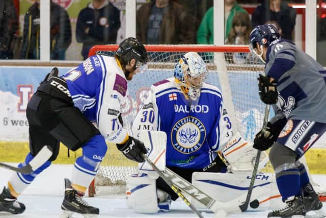 Phantoms' netminder Adam Long saves from Sheffield player-coach Greg Wood. Photo: Tom Scott - AMOimages.com.