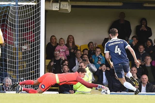 Luke McGee saves a penalty against Southend. Photo: David Lowndes.