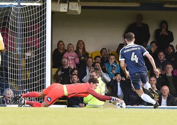 Luke McGee saves a penalty against Southend. Photo: David Lowndes.