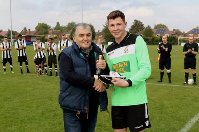 Peterborough Northern Star goalkeeper Dan George receives a momento ahead of his 100th start for the club. Photo: Tim Gates.