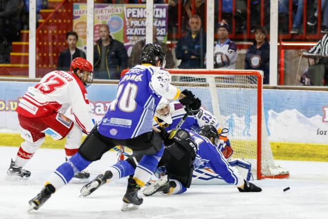 Scott Robson and Petr Stapanek help Janis Auzins keep out Sindon Wildcats. Photo: Tom Scott