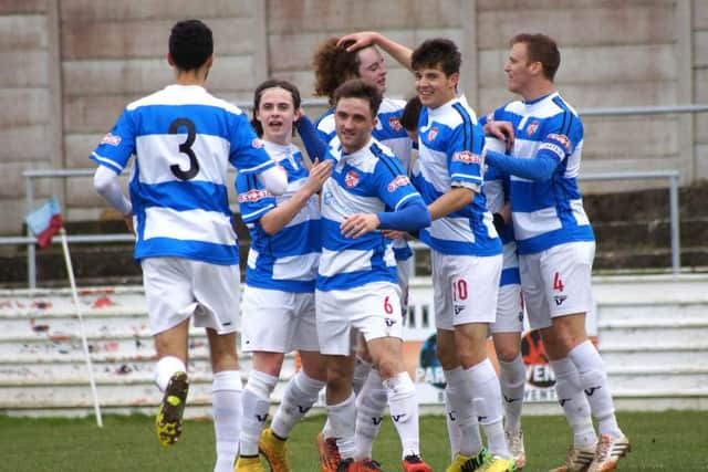 Chesham players celebrate a goal against Kettering last season.
