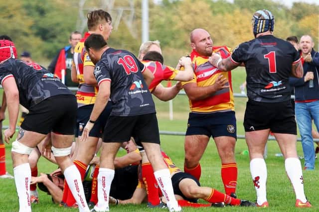 Borough player/coach Nico Steenkamp grapples with a very big Rugby Lions prop.