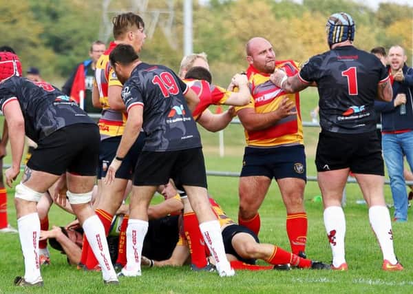 Borough player/coach Nico Steenkamp grapples with a very big Rugby Lions prop.