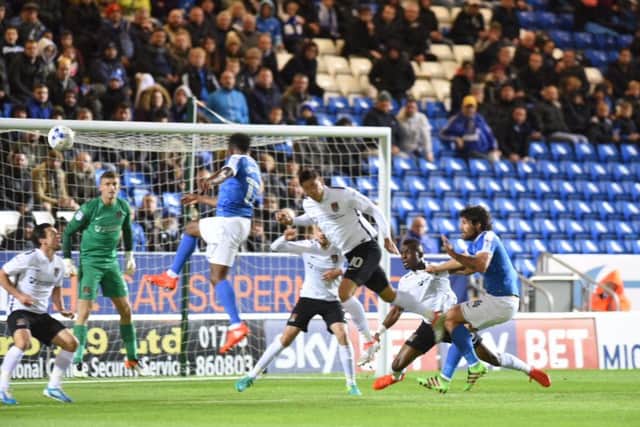 Shaquile Coulthirst scores for the opening goal for Posh against Northampton. Photo: David Lowndes.