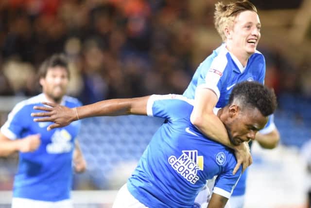 Chris Forrester helps Shaquile Coulthirst celebrate his goal against Northampton. Photo: David Lowndes.