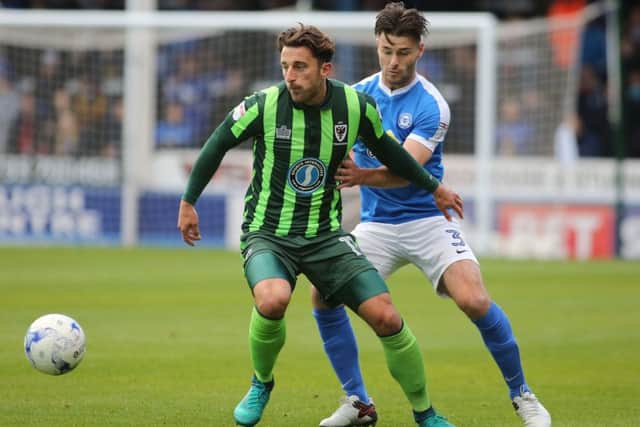Andrew Hughes of Peterborough United in action with Chris Whelpdale of AFC Wimbledon  - Mandatory by-line: Peterborough United Football Club Ltd / PaperPix- 2016 - 16/17 - FOOTBALL - ABAX Stadium - Peterborough, Cambs - Peterborough United v AFC Wimbledon
