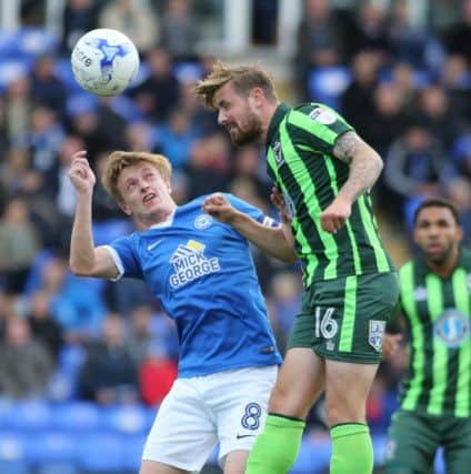 Chris Forrester of Peterborough United goes in for a header against Tom Beere of AFC Wimbledon  - Mandatory by-line: Peterborough United Football Club Ltd / PaperPix- 2016 - 16/17 - FOOTBALL - ABAX Stadium - Peterborough, Cambs - Peterborough United v AFC Wimbledon