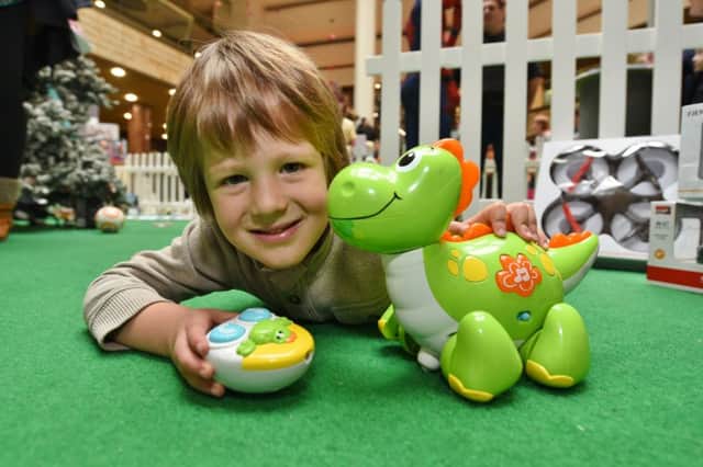 Christmas toy testing session outside John Lewis at Queensgate. Alessandro Bosnjnk (3) with remote control dinosaur EMN-161025-172715009