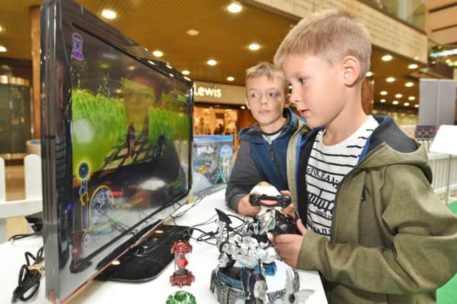 Christmas toy testing session outside John Lewis at Queensgate. Ben Farey (9) and Emmanuel Bosnjak (6) playing  Skylanders game. EMN-161025-172729009
