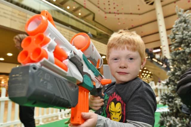 Christmas toy testing session outside John Lewis at Queensgate.  Charlie Pope (5) with NERF tristrike  shooter EMN-161025-172742009