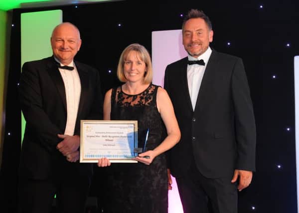 Peterborough Telegraph editor Mark Edwards with Julie Holroyd and awards host Kev Lawrence.