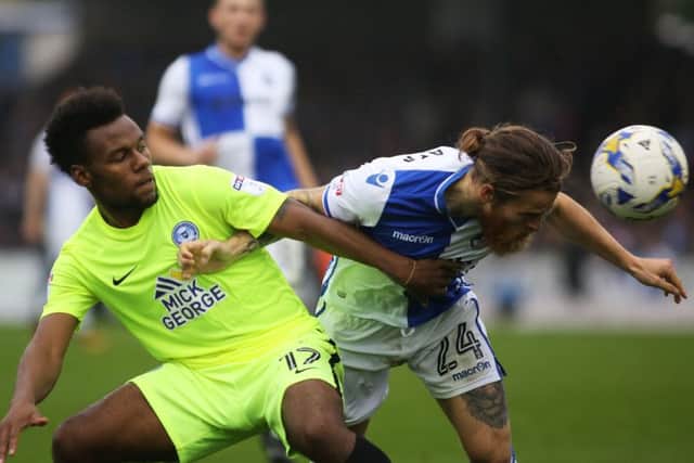 Posh striker Shaquile Coulthirst tangles with Stuart Sinclair of Bristol Rovers. Photo: Joe Dent/theposh.com.