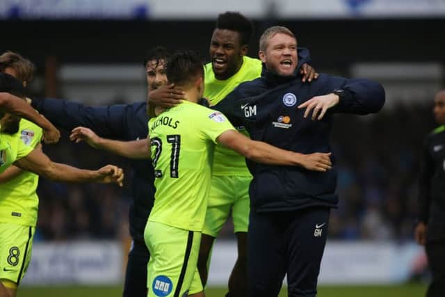 Posh boss Grant McCann can't hide his excitement after Tom Nichols (21) scored the winning goal at Bristol Rovers. Photo: Joe Dent/theposh.com.