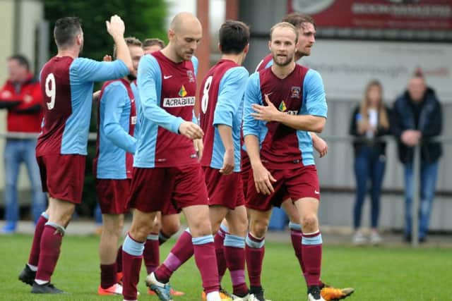 Deeping Rangers celebrate Charlie Coulson's winning goal against Desborough. Coulson is hidden. Photo: Tim Wilson.