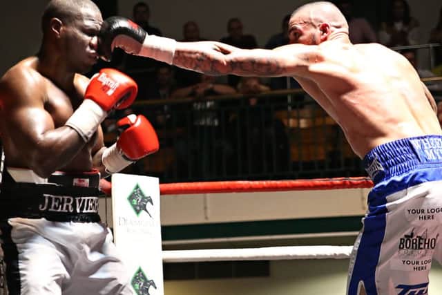 Karl Wheeler lands a jab during his fight with Ossie Jervier. Photo: Natalie Mayhew, ButterflyBoxing.