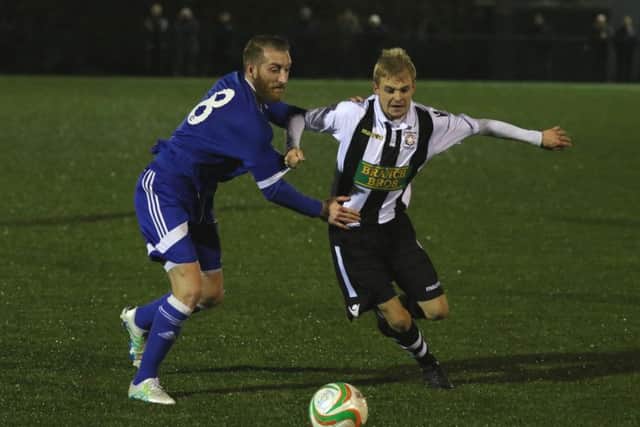 Sam Wilson (stripes) in action for Peterborough Northern Star against Yaxley. Photo: Tim Gates.