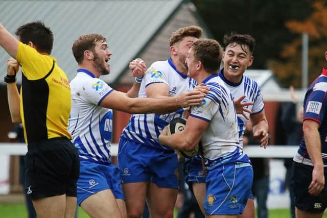 Tom Gulland is congratulated after scoring Lions' first try. Picture: Mick Sutterby