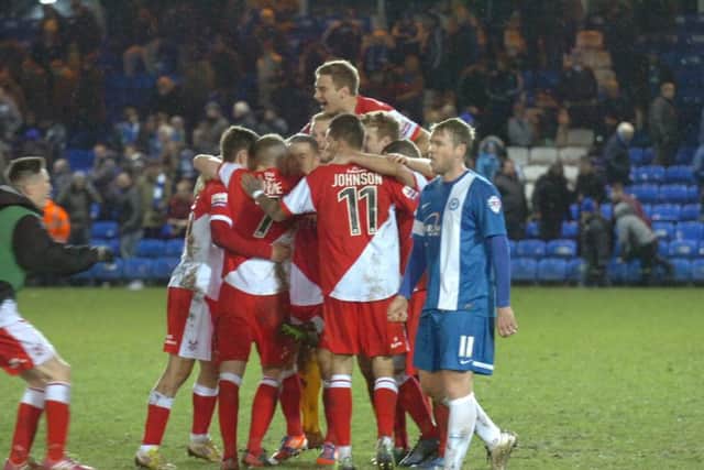 A scene of despair as Grant McCann troops off in front of celebrating Kidderminster players after an FA Cup tie in 2014.