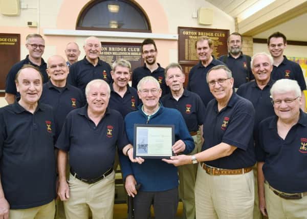 John Gould (front centre) receives long service award from the Hereward Harmony group at Orton Wistow community centr                                                       e EMN-161028-182510009