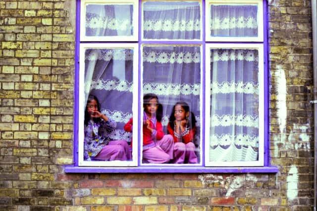 Picture shows Out from behind the Curtains  Original pic 1980 (left-right) Shehnaz Begum, her twin sister Rukhsana and their older sister Itrat were spotted sitting in the window of their house at 100 Cromwell Road in Peterborough in 1980. We often used to perch in the window and watch what was going on in the road, said Shehnaz. My twin sister and I were about seven and Itrat was nine.